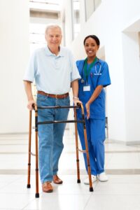 Nurse demonstrating use of mobility aids after joint replacement surgery