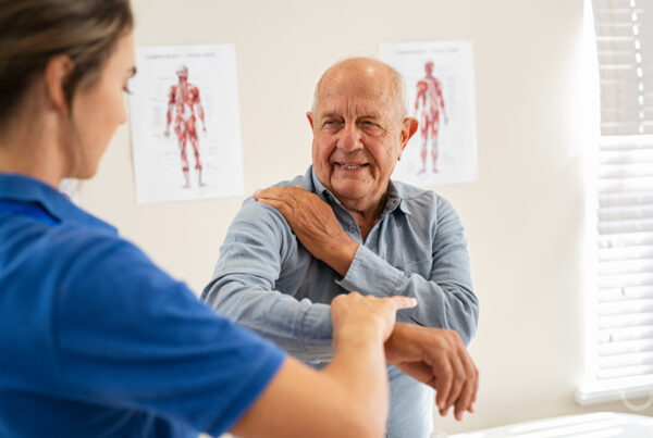Physical Therapist working with senior patient with shoulder pain